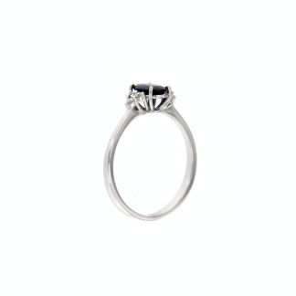 Anello in oro bianco 18kt con zaffiro blu ovale 7x5mm e tre diamanti G VS1 per lato